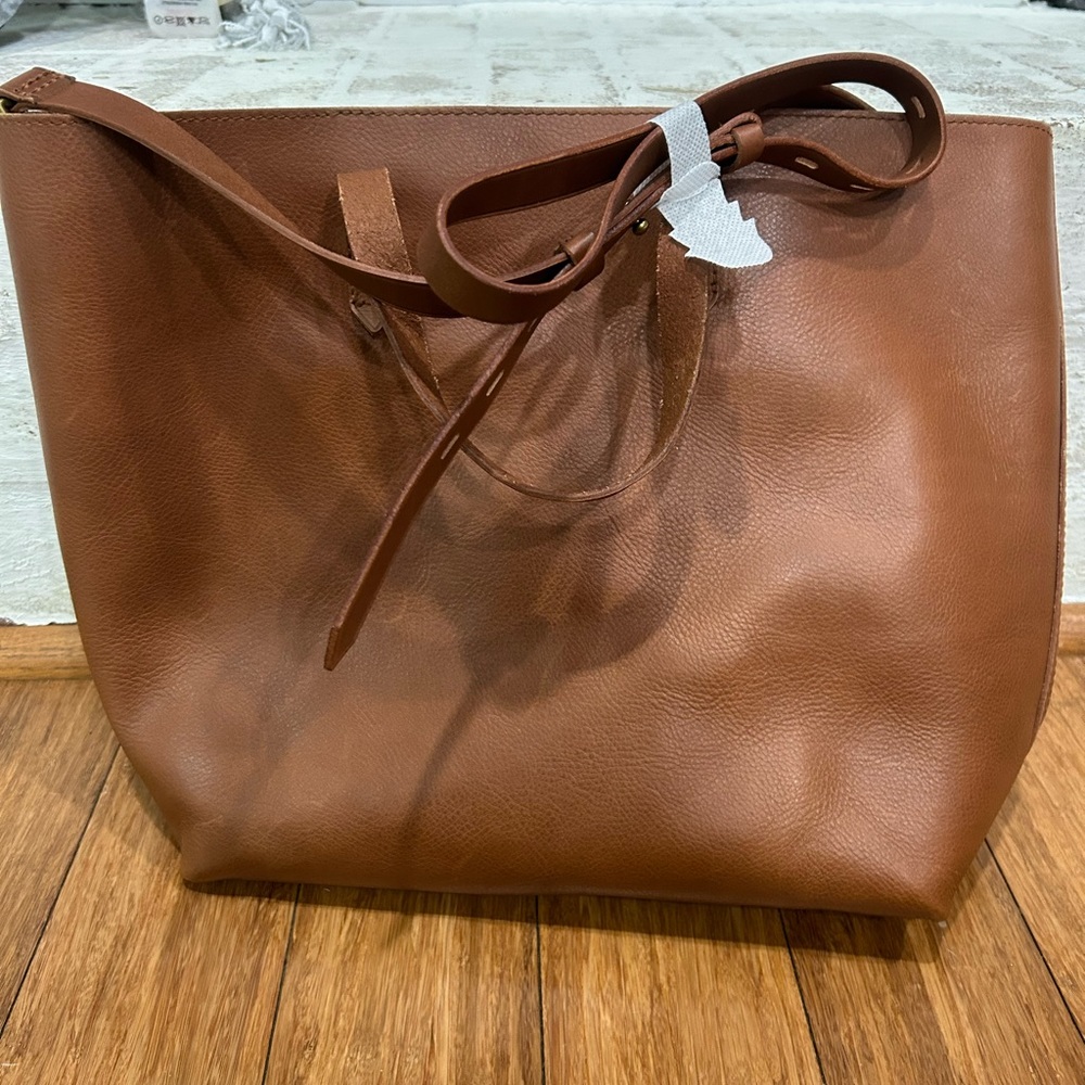 The Madewell zip-top transport crossbody in English saddle.